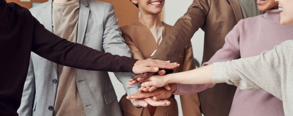 group with hands in a huddle