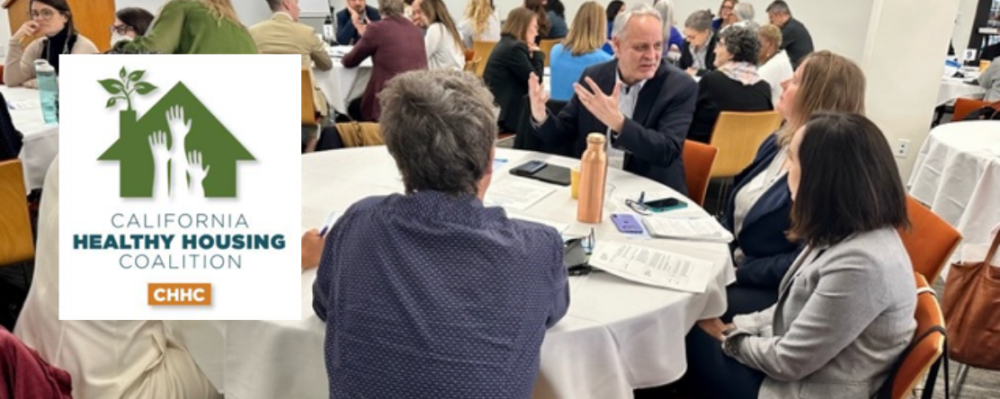 group of people speaking at a table