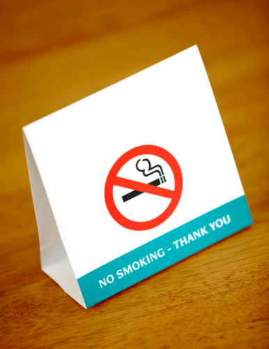 "NO SMOKING" sign on table