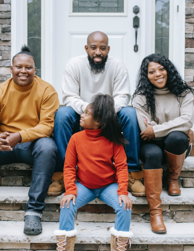 people sitting in front of house