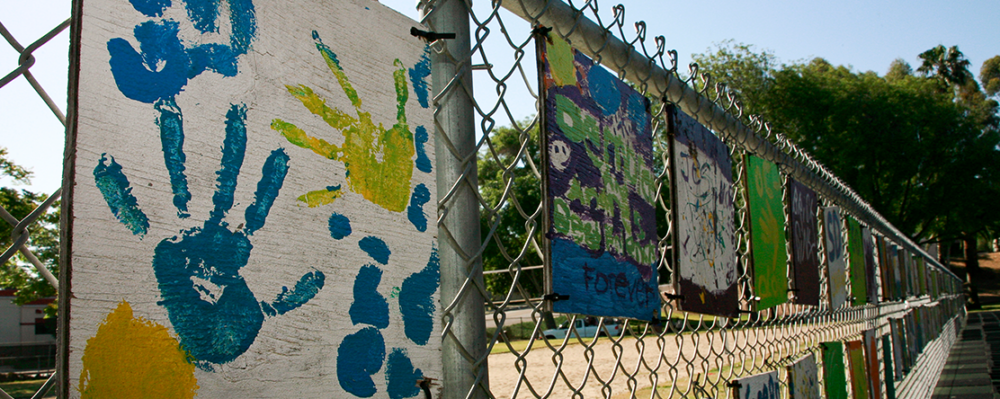 children's artwork on fence