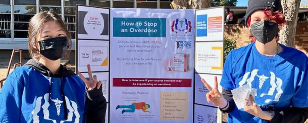 students in front of poster