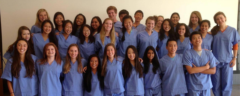 Faces students wearing scrubs