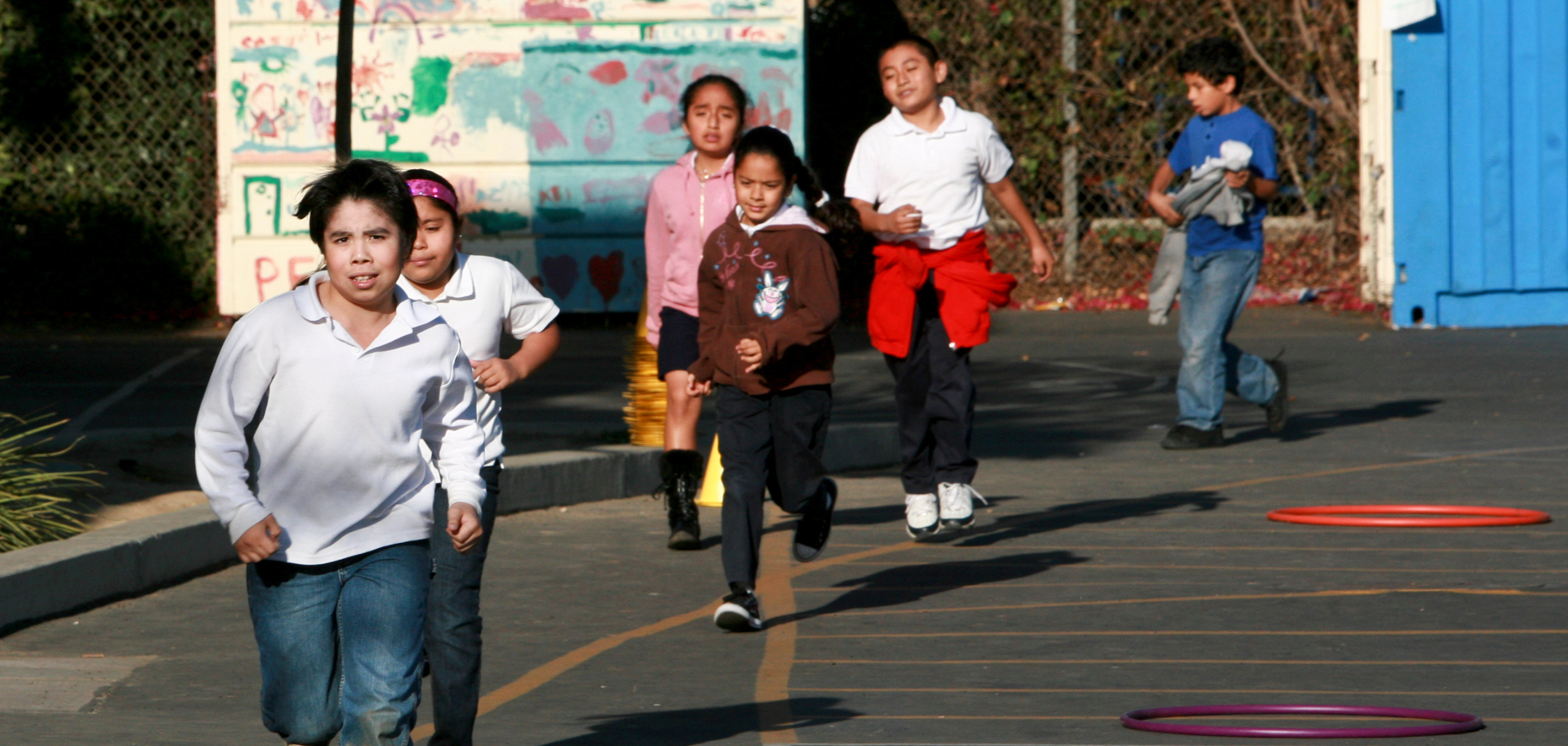 Students stretch, run and play exercise games at an after-school program
