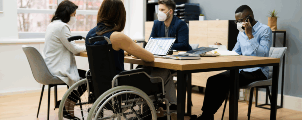 woman in wheelchair working at a table