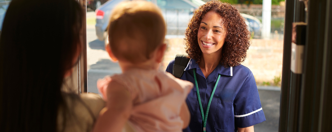 community health worker visiting mom and baby at home
