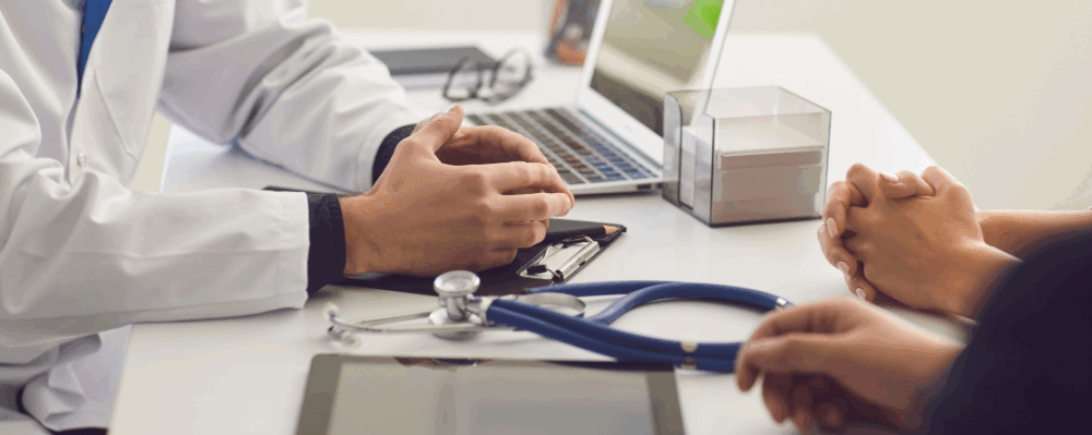 doctor with patients near laptop and tablet