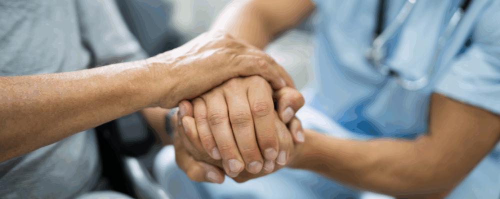 patient holding doctors hand