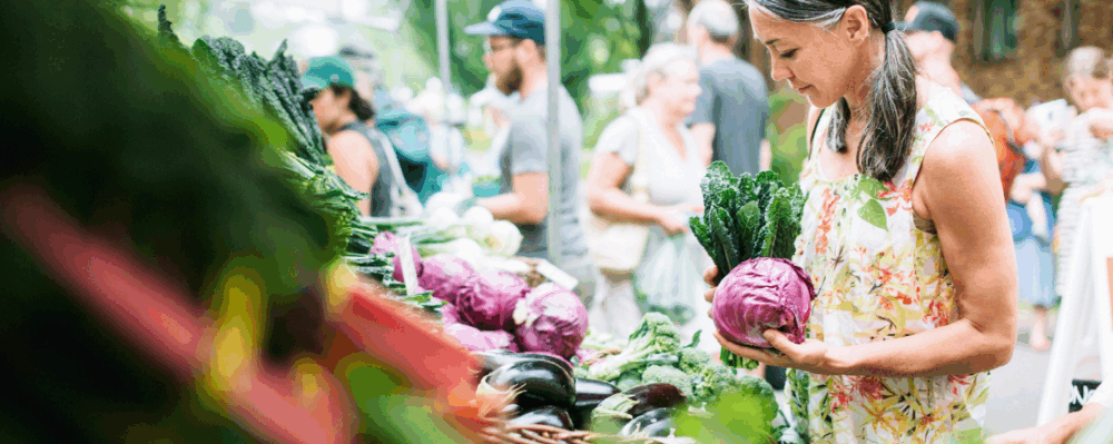 woman buying produce at farmer's market