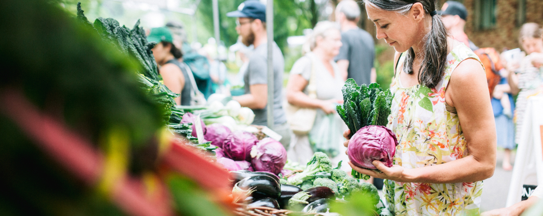woman buying produce at farmer's market