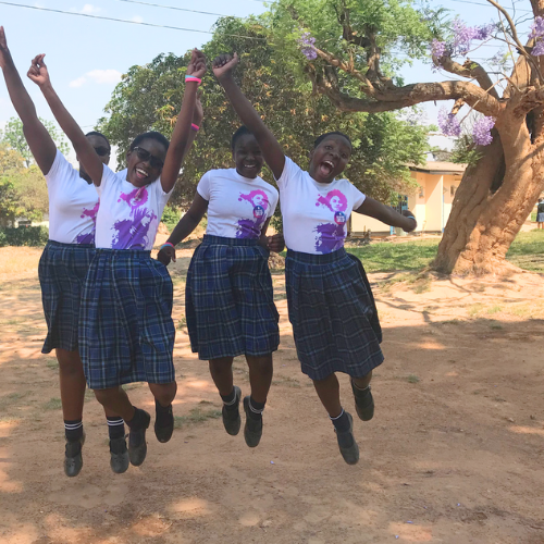 girls jumping with fists in the air