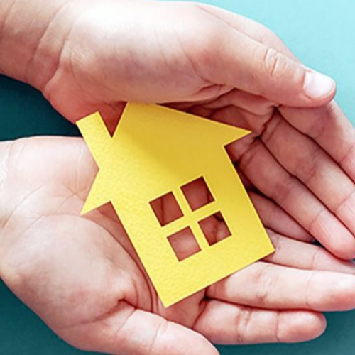 hands holding a paper house