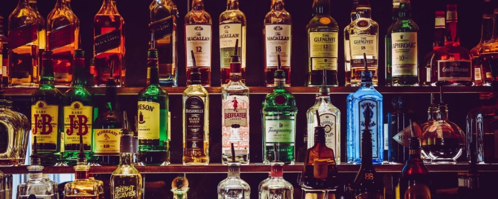 Bottles of alcohol on shelf in bar