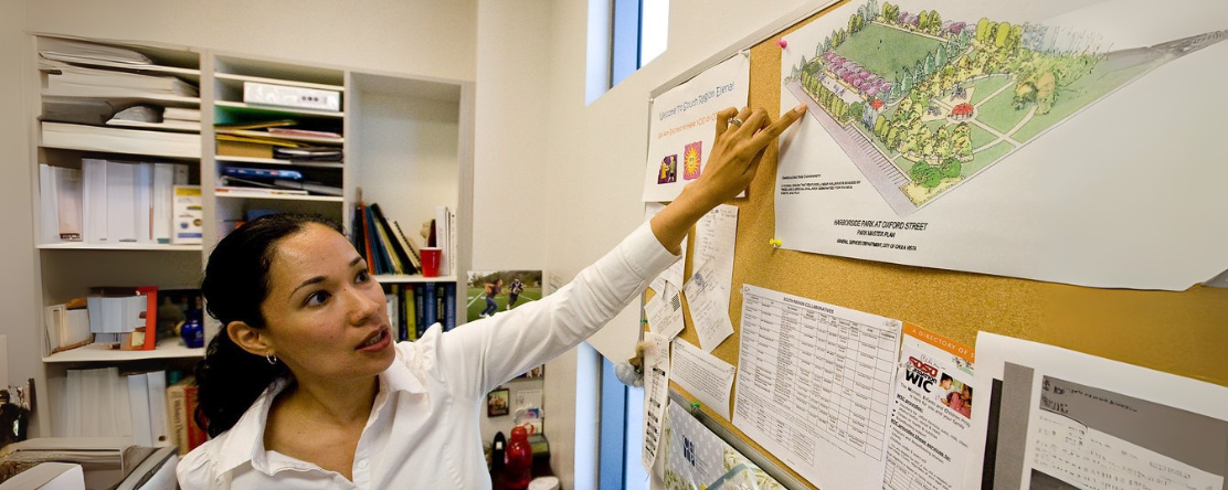 woman pointing to map of community development
