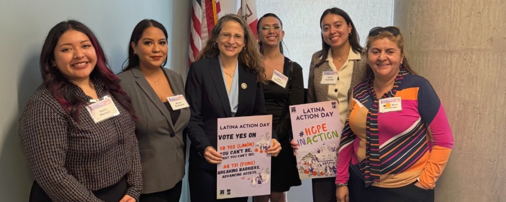 group photo of women advocates holding signs on Latina Action Day