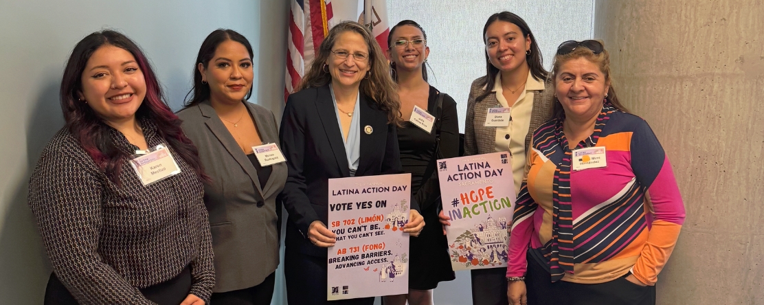 group photo of women advocates holding signs on Latina Action Day