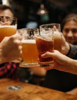 people holding jugs of beer