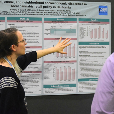 woman standing in front of poster with data