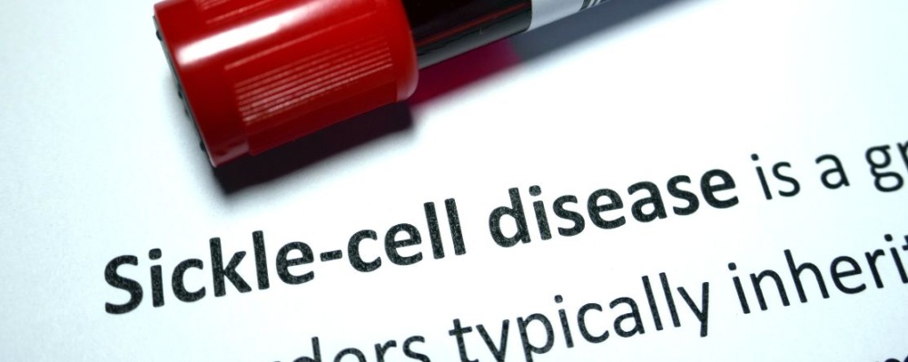 vile with blood on top of paper that says sickle cell disease
