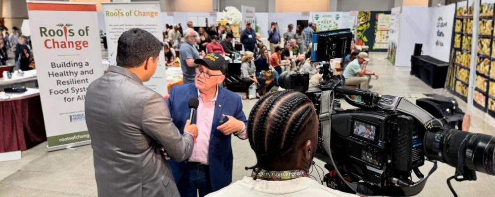 Michael Dimmock speaking to reporter at Terra Madres event