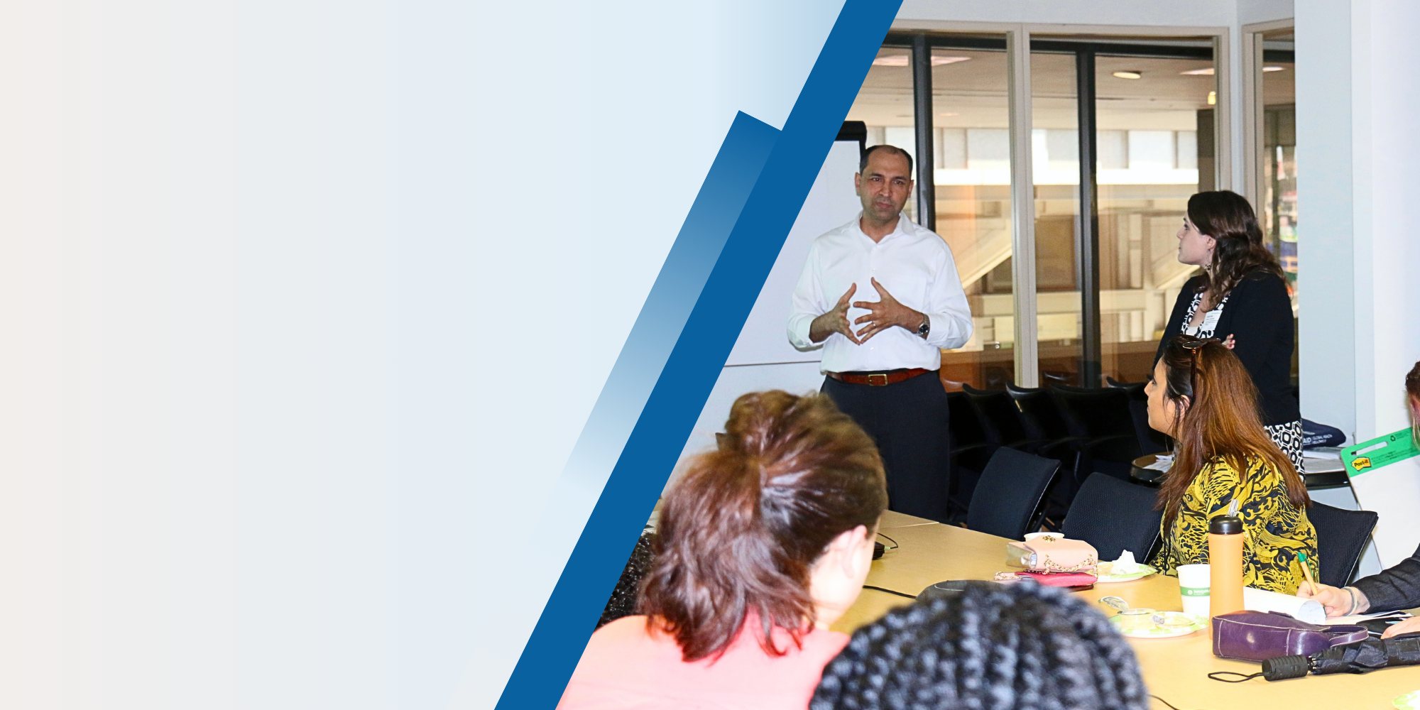 PHI expert lecturing group of people sitting at table