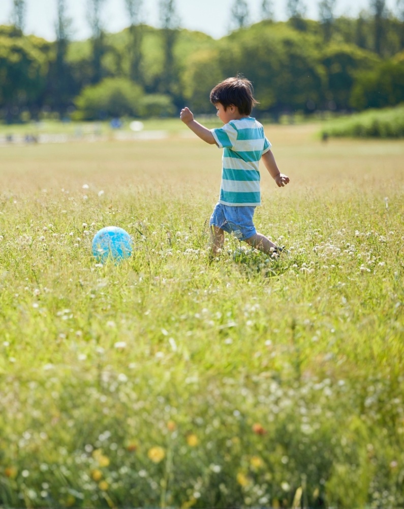 child playing with ball in field