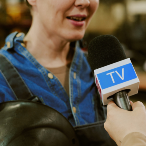 woman being interviewed by a reporter with a microphone