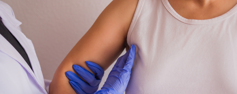 medical professional provides breast cancer screening on patient