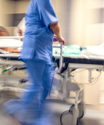 healthcare worker rushing in a hospital emergency department