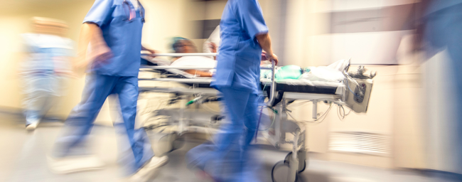 healthcare worker rushing in a hospital emergency department