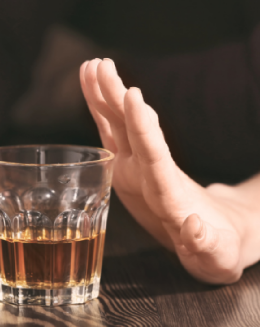 person holding their hand refusing alcohol