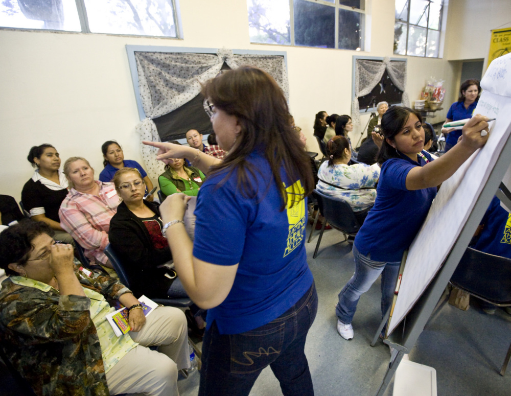 Staff from a community-based organization facilitate a discussion among community members